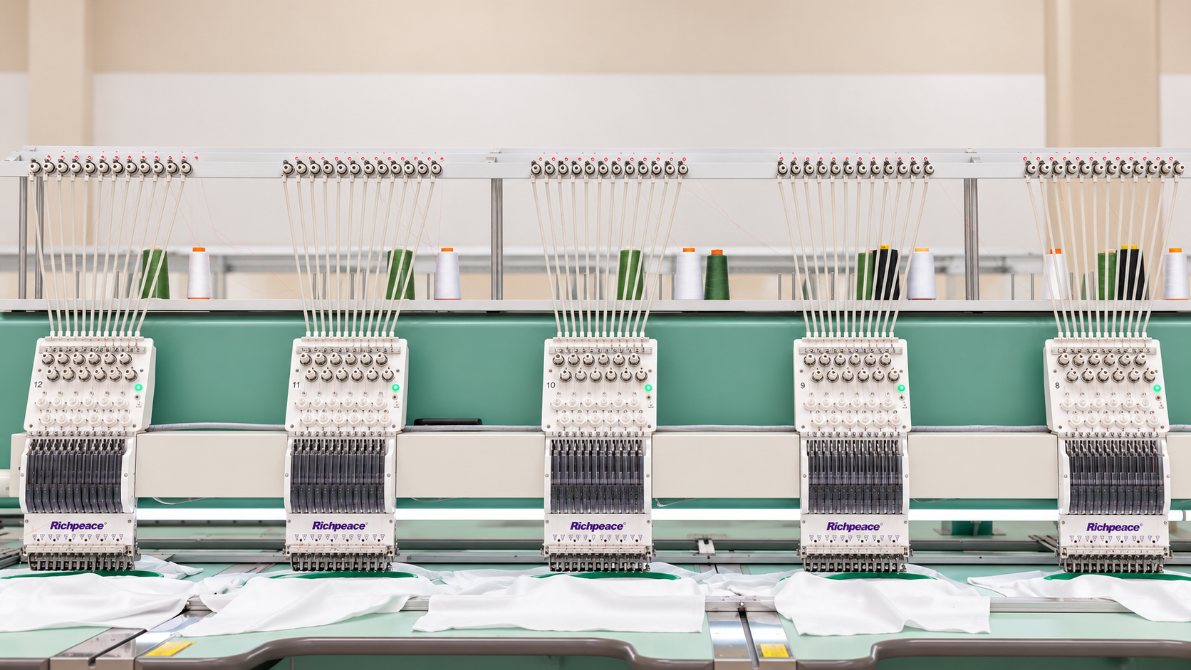 Industrial embroidery machines finishing white garments