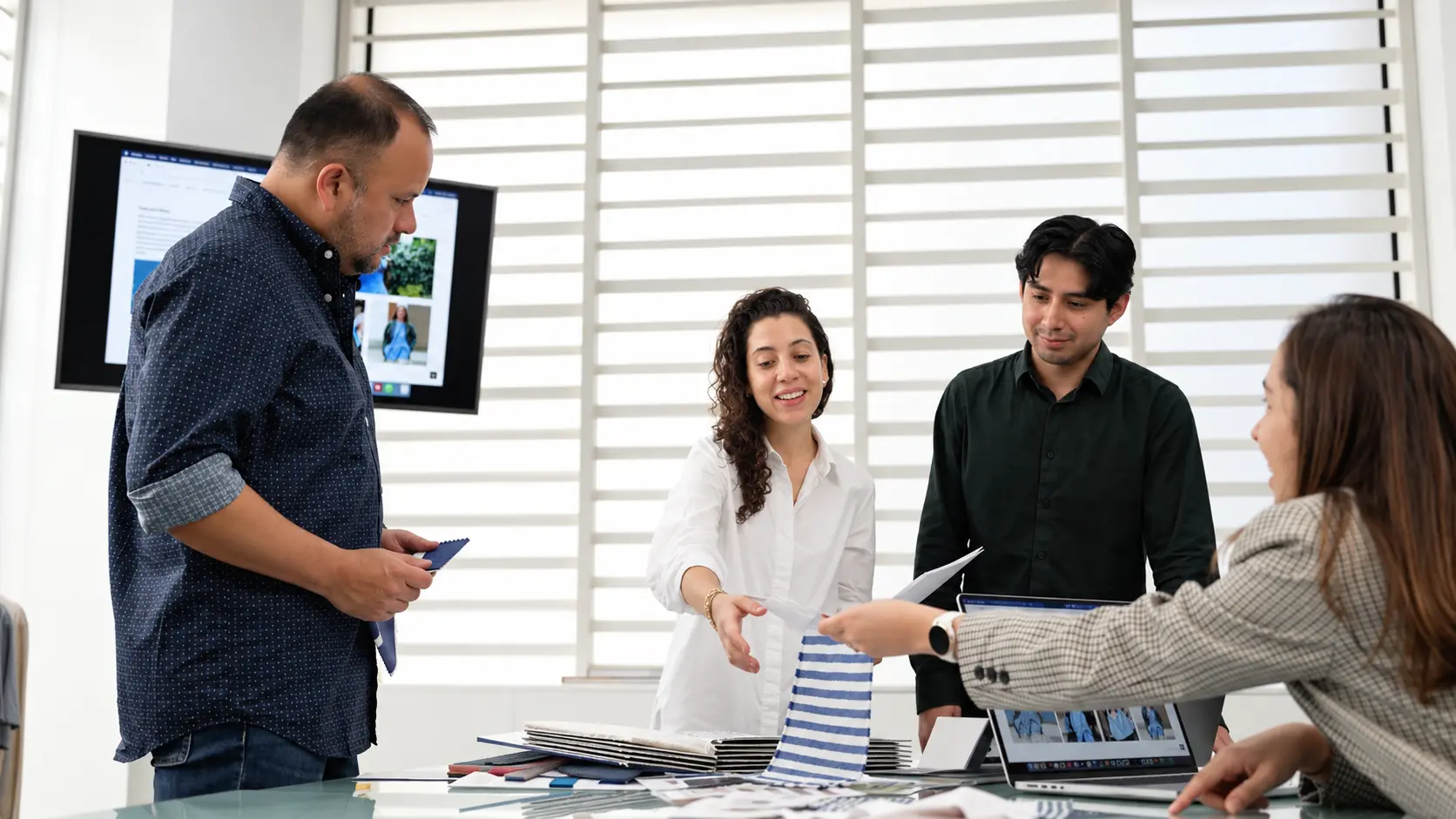 The WTS team reviewing fabric swatches around the table